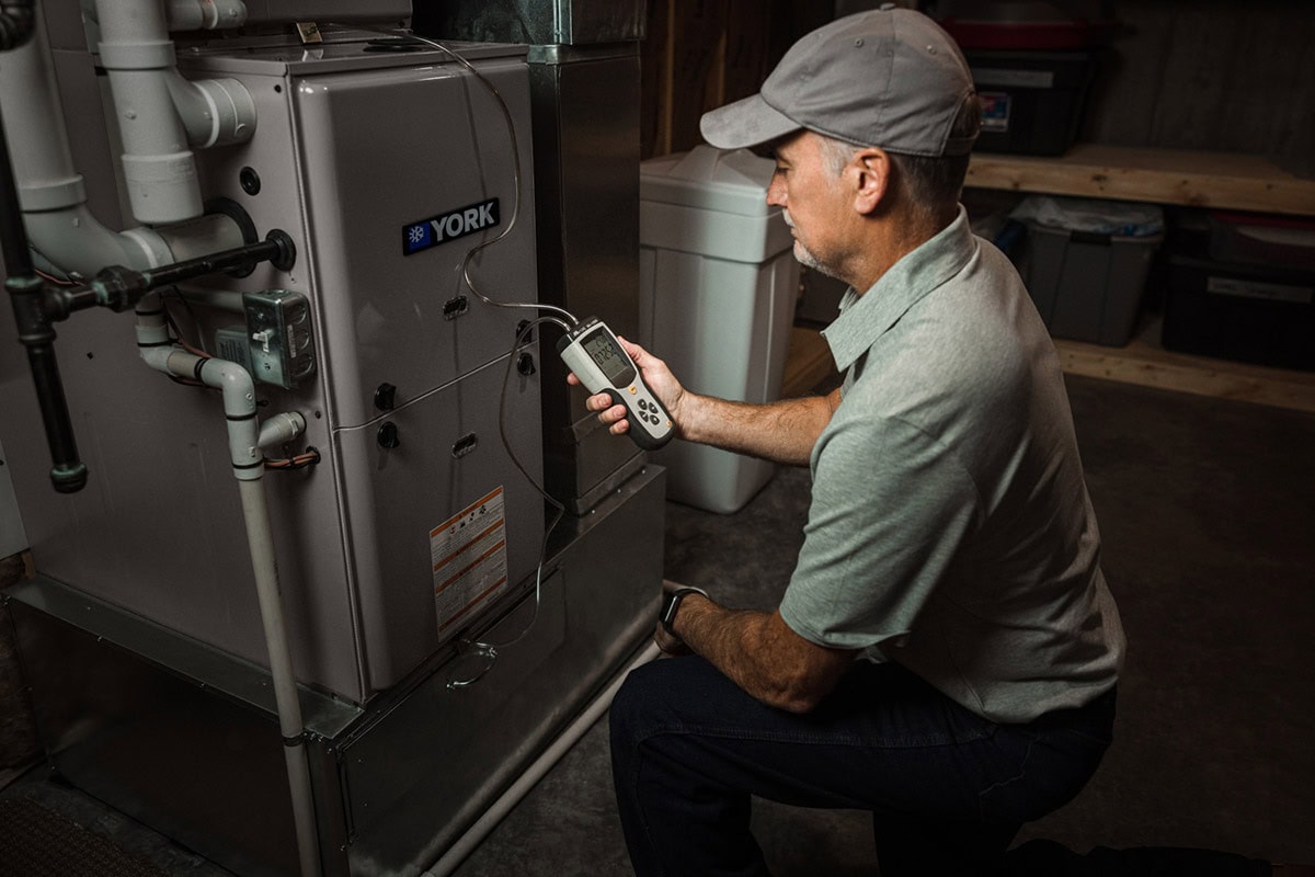 A technician performing maintenance on a YORK system.